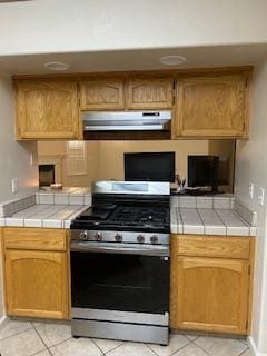 220 S Double Tree Way, Madera, CA 93637 - kitchen featuring gas stove, tile countertops, under cabinet range hood, and light tile patterned flooring