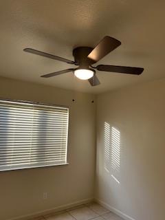 220 S Double Tree Way, Madera, CA 93637 - empty room with ceiling fan, light tile patterned flooring, and plenty of natural light
