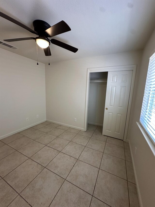 220 S Double Tree Way, Madera, CA 93637 - unfurnished bedroom with light tile patterned floors, a closet, and ceiling fan