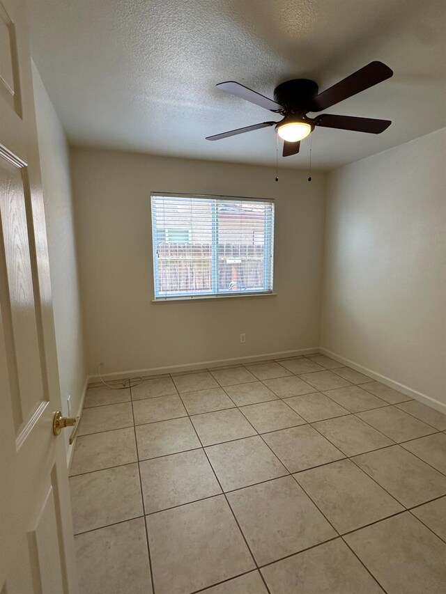 220 S Double Tree Way, Madera, CA 93637 - spare room with light tile patterned floors, ceiling fan, and a textured ceiling