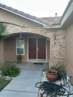 220 S Double Tree Way, Madera, CA 93637 - doorway to property featuring stone siding and stucco siding