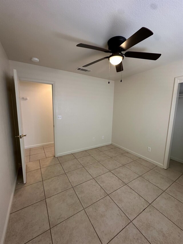 220 S Double Tree Way, Madera, CA 93637 - unfurnished bedroom with light tile patterned floors, ceiling fan, a textured ceiling, and a closet