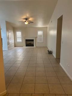 220 S Double Tree Way, Madera, CA 93637 - unfurnished living room featuring ceiling fan, light tile patterned floors, and a fireplace