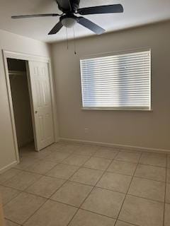 220 S Double Tree Way, Madera, CA 93637 - unfurnished bedroom featuring light tile patterned floors, a closet, and a ceiling fan