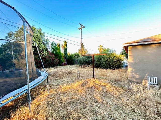 1445 E Cornell Ave, Fresno, CA 93704 - view of yard featuring a trampoline