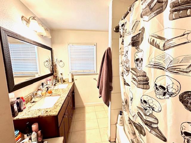1445 E Cornell Ave, Fresno, CA 93704 - full bathroom with double vanity, tile patterned flooring, and shower / bathtub combination with curtain
