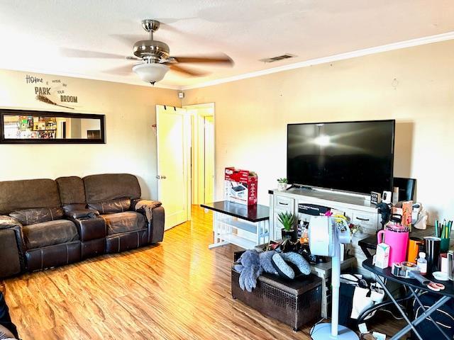 1445 E Cornell Ave, Fresno, CA 93704 - living area with a ceiling fan, crown molding, and wood finished floors