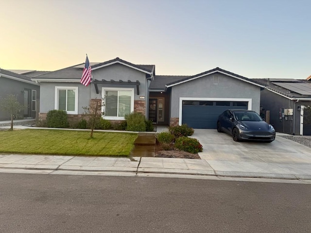 825 Spring St W, Madera, CA 93636 - single story home featuring stucco siding, an attached garage, a lawn, driveway, and stone siding