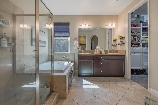 11337 N Cherry Sage Ave, Fresno, CA 93730 - bathroom with double vanity, a garden tub, a stall shower, tile patterned flooring, and a spacious closet