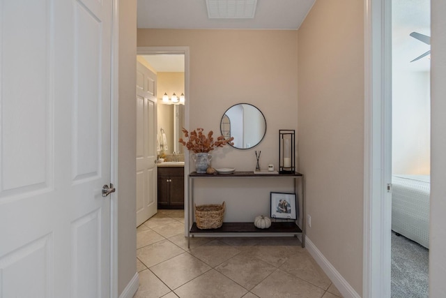 11337 N Cherry Sage Ave, Fresno, CA 93730 - hallway with light tile patterned floors and baseboards