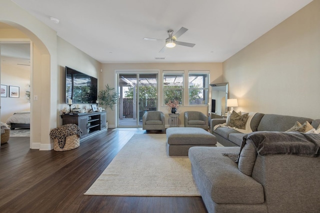 11337 N Cherry Sage Ave, Fresno, CA 93730 - living area featuring arched walkways, ceiling fan, and dark wood-style flooring