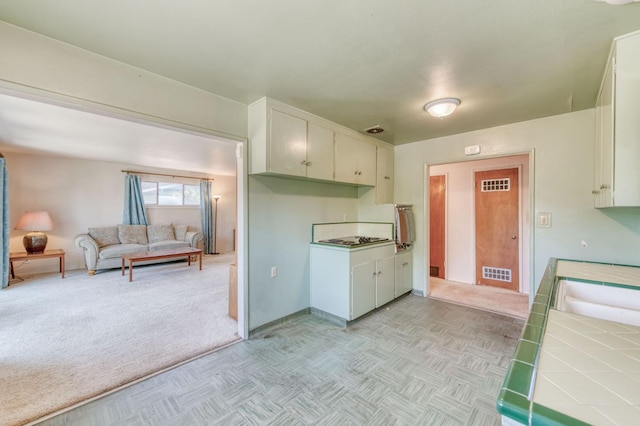 2120 Richard Ave, Sanger, CA 93657 - kitchen featuring tile countertops, light carpet, white cabinets, and open floor plan