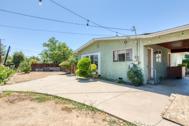 2120 Richard Ave, Sanger, CA 93657 - view of home's exterior with a fenced backyard, stucco siding, and a patio area