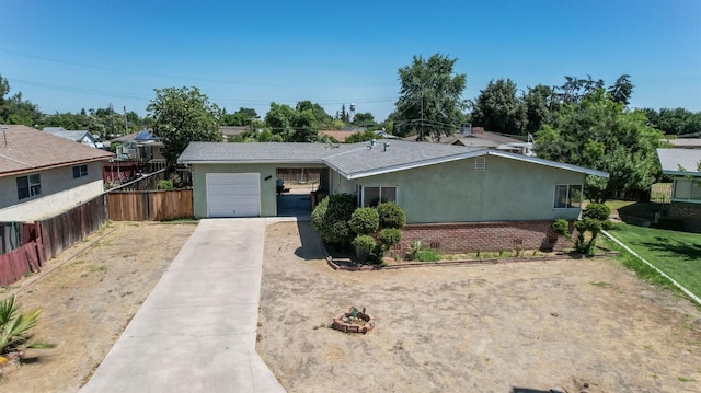 2120 Richard Ave, Sanger, CA 93657 - ranch-style house featuring concrete driveway, stucco siding, and a garage