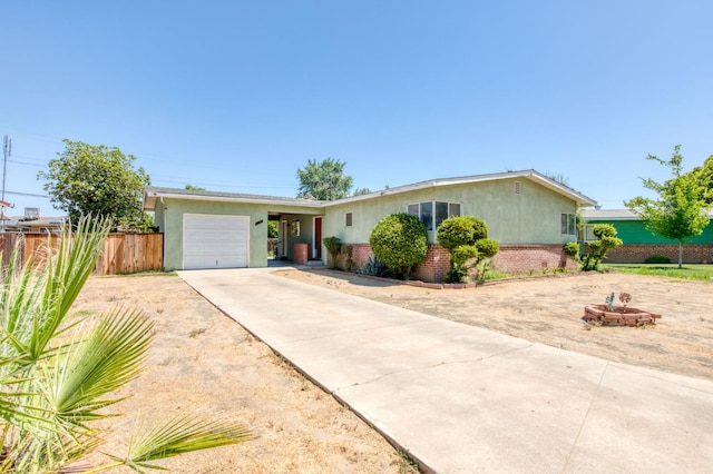 2120 Richard Ave, Sanger, CA 93657 - ranch-style home with stucco siding, an attached garage, concrete driveway, and brick siding