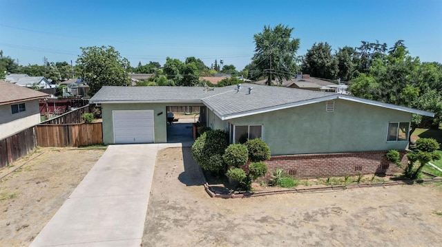 2120 Richard Ave, Sanger, CA 93657 - ranch-style house with driveway, stucco siding, and an attached garage