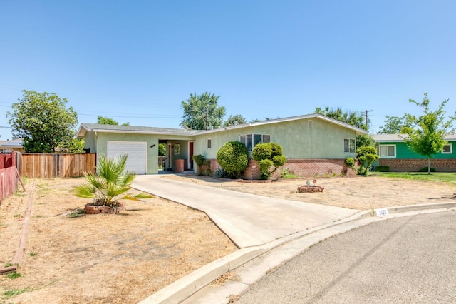 2120 Richard Ave, Sanger, CA 93657 - ranch-style home with stucco siding, a garage, and driveway