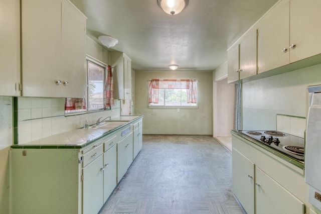 2120 Richard Ave, Sanger, CA 93657 - kitchen featuring tile countertops, black electric stovetop, tasteful backsplash, and fridge