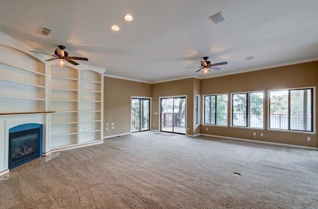 27415 Sky Harbour Rd, Friant, CA 93626 - unfurnished living room featuring a ceiling fan, healthy amount of natural light, a glass covered fireplace, carpet flooring, and crown molding