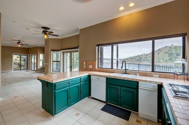 27415 Sky Harbour Rd, Friant, CA 93626 - kitchen with white dishwasher, tile counters, a peninsula, green cabinetry, and crown molding
