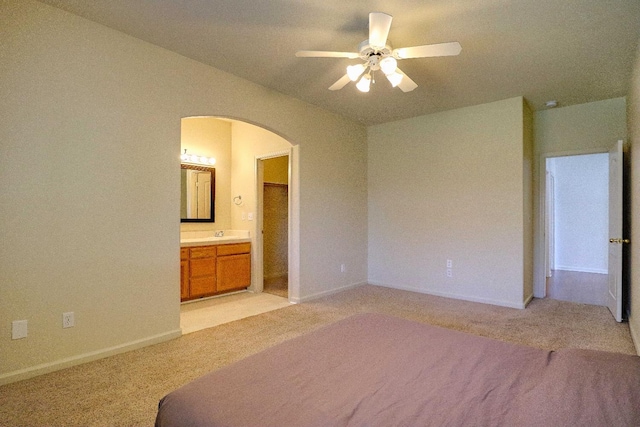 5684 W Holland Ave, Fresno, CA 93722 - unfurnished bedroom featuring light colored carpet, arched walkways, ensuite bath, a ceiling fan, and vaulted ceiling