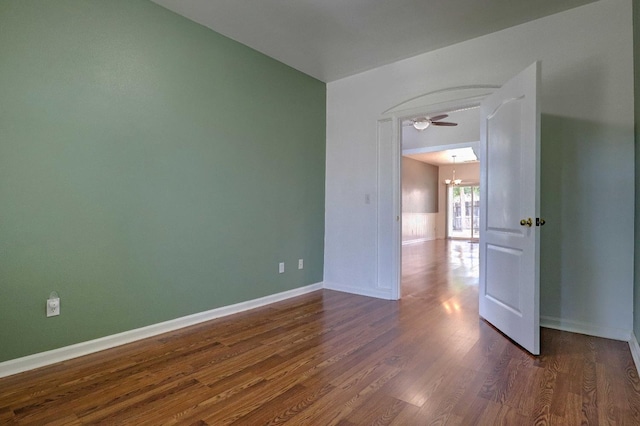 5684 W Holland Ave, Fresno, CA 93722 - unfurnished room featuring a chandelier, dark wood-style floors, ceiling fan, and vaulted ceiling