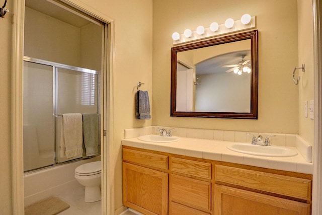 5684 W Holland Ave, Fresno, CA 93722 - bathroom with double vanity, combined bath / shower with glass door, tile patterned flooring, and a ceiling fan