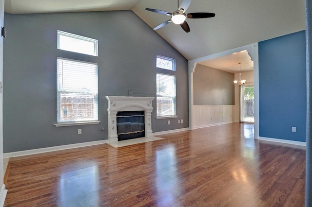 5684 W Holland Ave, Fresno, CA 93722 - unfurnished living room with a chandelier, high vaulted ceiling, ceiling fan, a high end fireplace, and wood finished floors