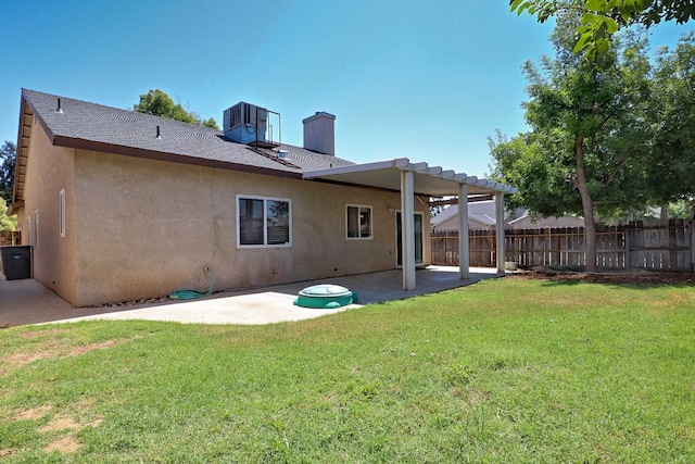 5684 W Holland Ave, Fresno, CA 93722 - back of property with stucco siding, a chimney, and a patio