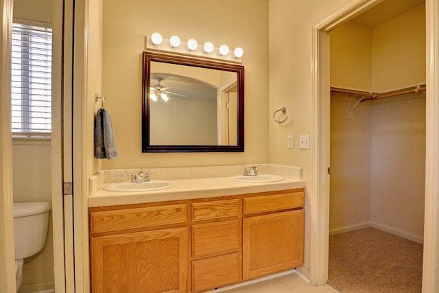 5684 W Holland Ave, Fresno, CA 93722 - bathroom with double vanity, a spacious closet, and ceiling fan