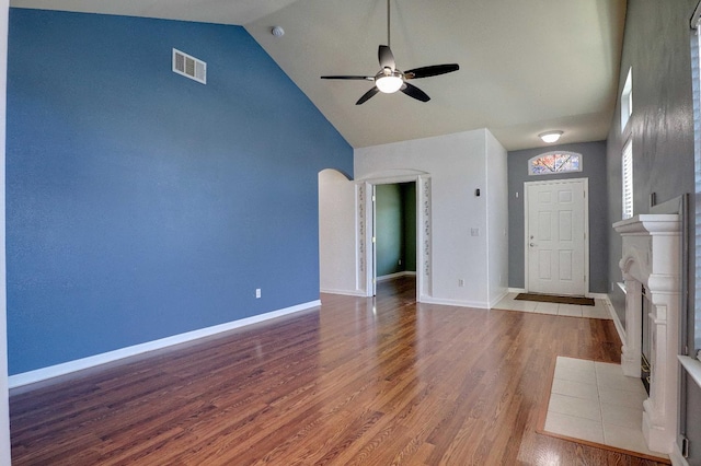 5684 W Holland Ave, Fresno, CA 93722 - spare room featuring ceiling fan, wood finished floors, high vaulted ceiling, and arched walkways