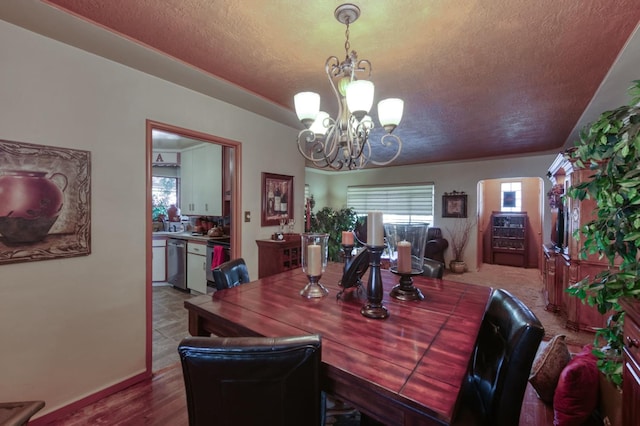 43125 Rd 80, Dinuba, CA 93618 - dining space featuring a textured ceiling, a chandelier, and healthy amount of natural light