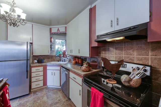 43125 Rd 80, Dinuba, CA 93618 - kitchen with appliances with stainless steel finishes, under cabinet range hood, tile counters, a chandelier, and white cabinets