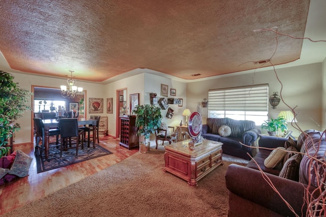 43125 Rd 80, Dinuba, CA 93618 - living area with a textured ceiling, a chandelier, wood finished floors, and plenty of natural light