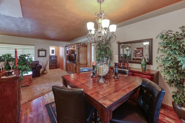 43125 Rd 80, Dinuba, CA 93618 - dining space with a chandelier, a textured ceiling, wood finished floors, and arched walkways