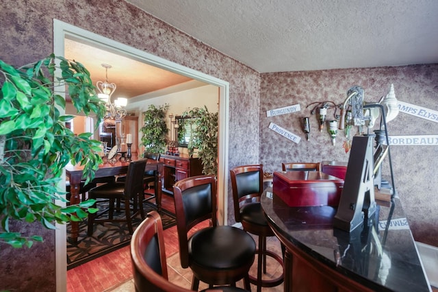 43125 Rd 80, Dinuba, CA 93618 - bar with a chandelier, a textured ceiling, wallpapered walls, and wood finished floors