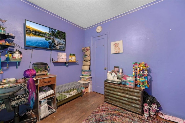 4832 E Illinois Ave, Fresno, CA 93727 - bedroom with wood finished floors and a textured ceiling