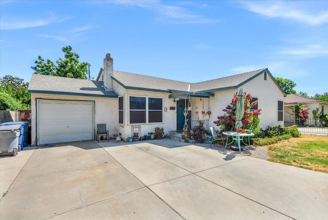 4832 E Illinois Ave, Fresno, CA 93727 - single story home featuring a garage, stucco siding, driveway, and a chimney