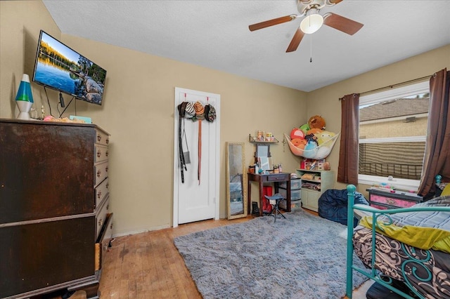 4832 E Illinois Ave, Fresno, CA 93727 - bedroom with wood finished floors and a ceiling fan