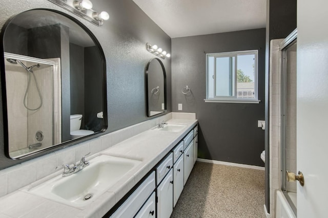 1580 Armstrong Ave, Clovis, CA 93611 - bathroom featuring double vanity, speckle patterned floor, and bath / shower combo with glass door