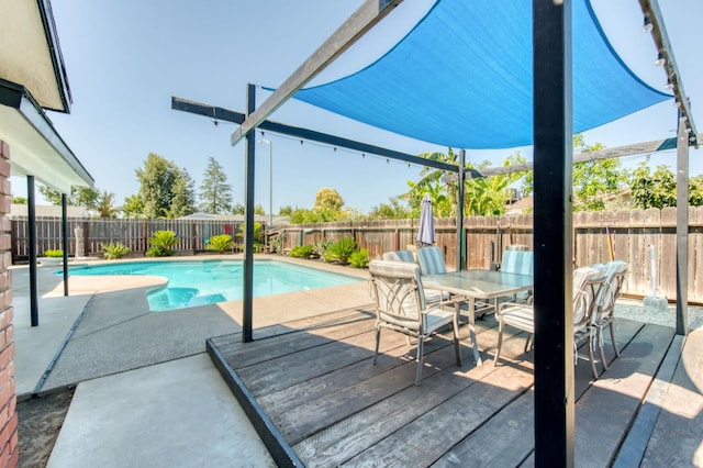1580 Armstrong Ave, Clovis, CA 93611 - view of swimming pool featuring outdoor dining space, a fenced backyard, and a deck