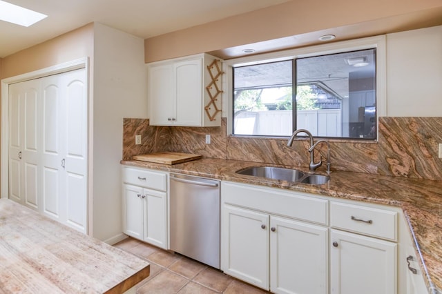 5039 N Van Ness Blvd, Fresno, CA 93711 - kitchen with stainless steel dishwasher, a skylight, tasteful backsplash, white cabinetry, and light stone counters