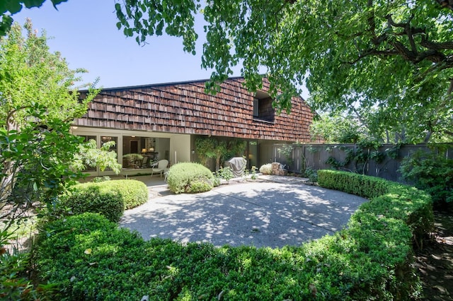 5039 N Van Ness Blvd, Fresno, CA 93711 - rear view of property featuring a patio and mansard roof