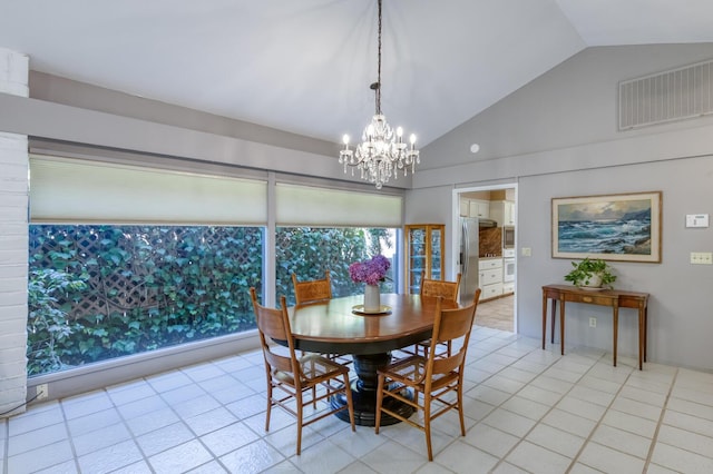 5039 N Van Ness Blvd, Fresno, CA 93711 - dining room with a chandelier, vaulted ceiling, and light tile patterned floors