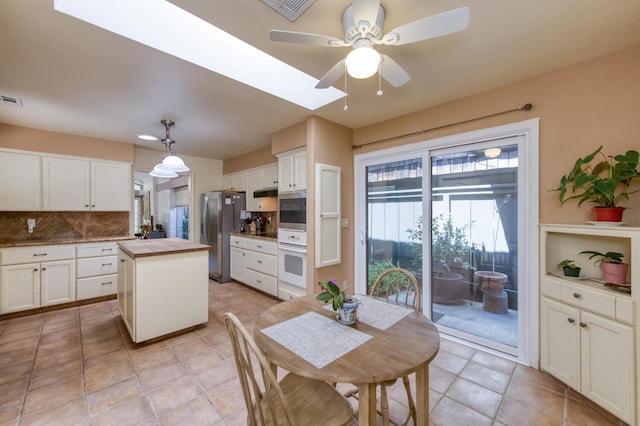 5039 N Van Ness Blvd, Fresno, CA 93711 - dining area featuring a ceiling fan and a skylight