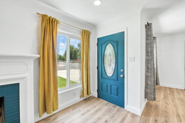 4611 N Safford Ave, Fresno, CA 93704 - foyer entrance featuring healthy amount of natural light, light wood-style flooring, and a fireplace