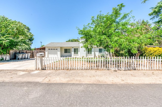4611 N Safford Ave, Fresno, CA 93704 - view of front of house featuring an attached garage, a fenced front yard, concrete driveway, and stucco siding