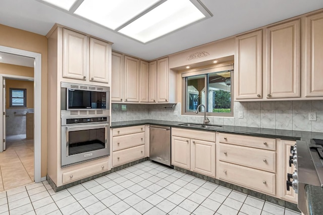 3547 W Locust Ave, Fresno, CA 93711 - kitchen with appliances with stainless steel finishes, light brown cabinets, dark countertops, and light tile patterned floors
