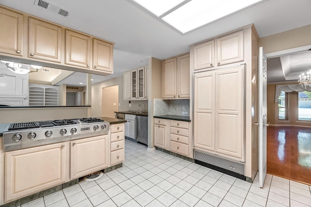 3547 W Locust Ave, Fresno, CA 93711 - kitchen with stainless steel appliances, a chandelier, tasteful backsplash, glass insert cabinets, and dark countertops