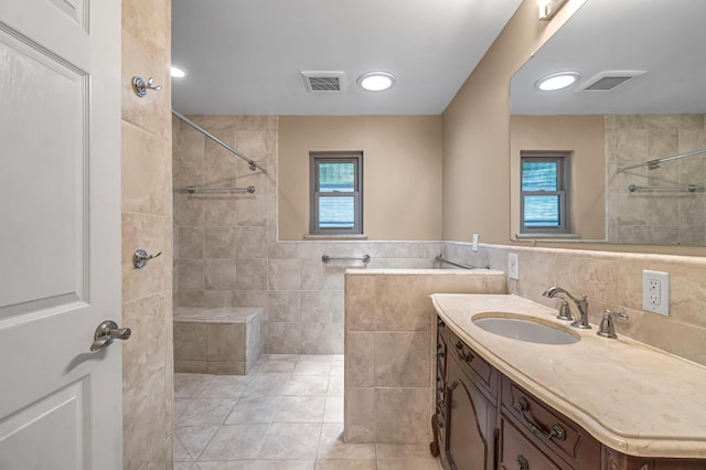 3547 W Locust Ave, Fresno, CA 93711 - full bathroom with tile walls, vanity, tiled shower, and tile patterned flooring